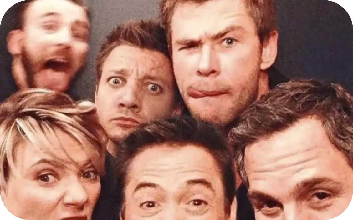 Six friends making funny faces and posing closely together for a group photo.