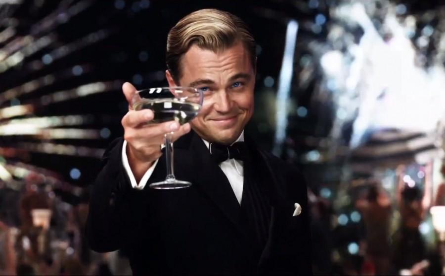 Man in a tuxedo raising a champagne glass in a toast.