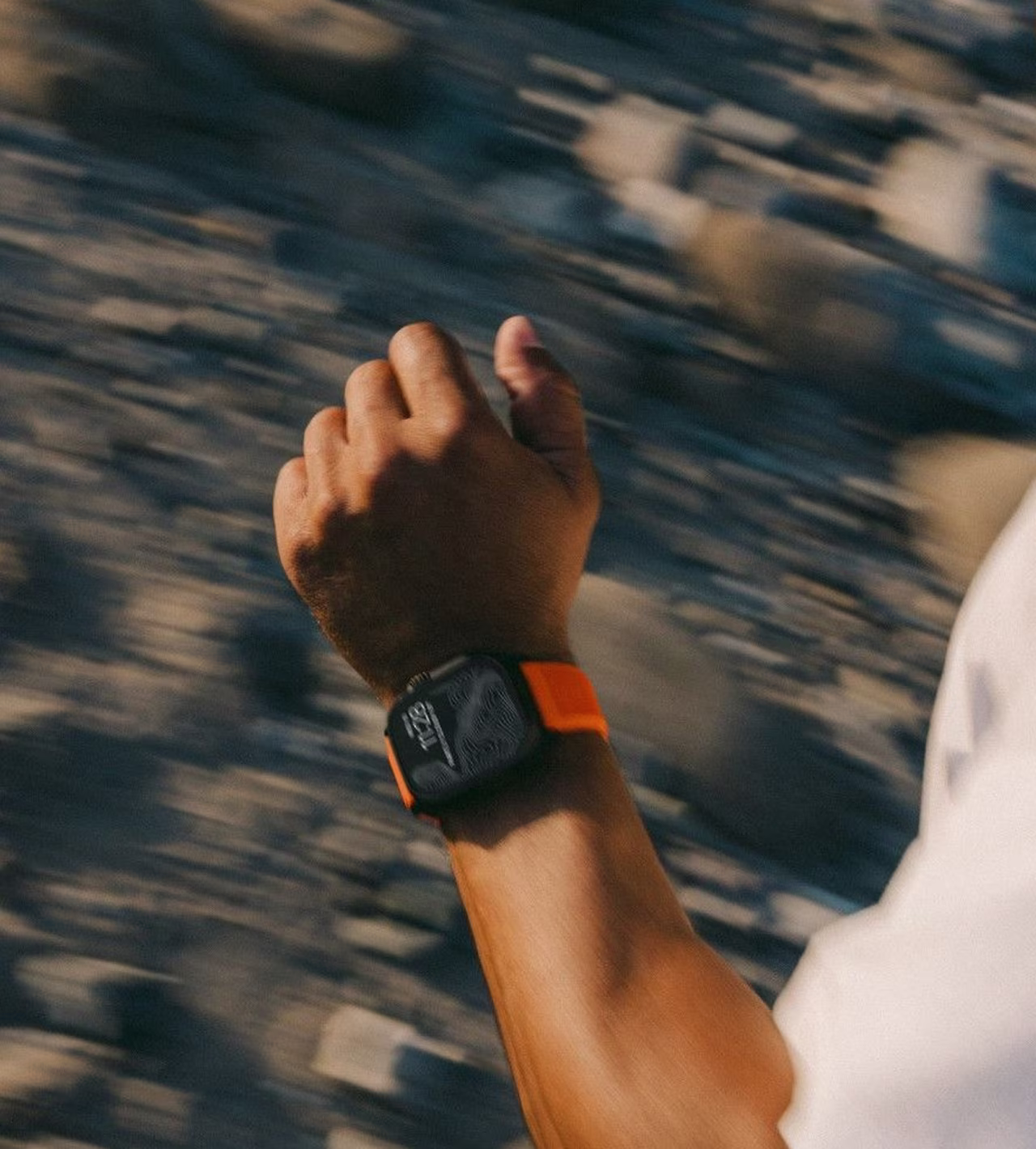 Close up shot of a smartwatch on a running man's wrist.