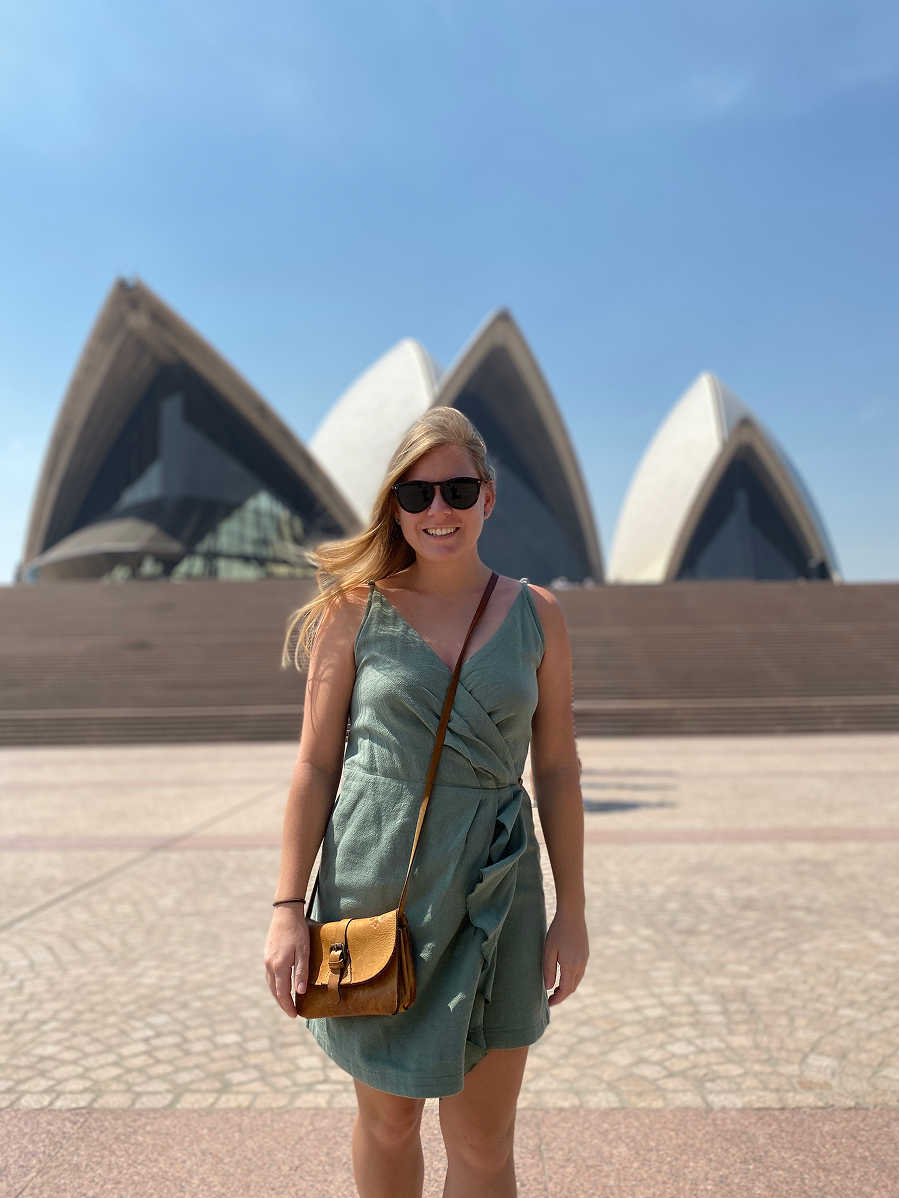 Girl smiling in front of opera house