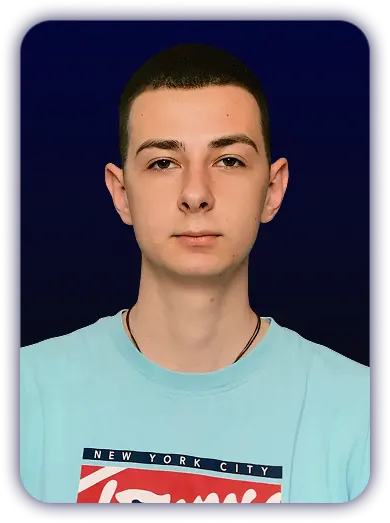 Portrait of a young man with short dark hair wearing a light blue shirt with New York City text on a dark blue background.