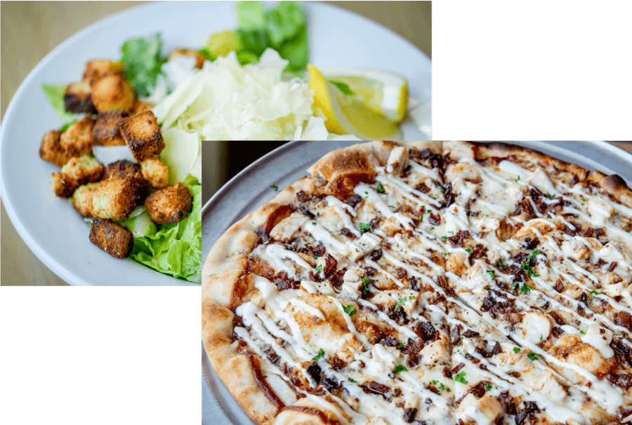 Plate with crispy croutons, lettuce, cabbage, and lemon wedge alongside a pizza topped with chicken, bacon bits, and white drizzle sauce.