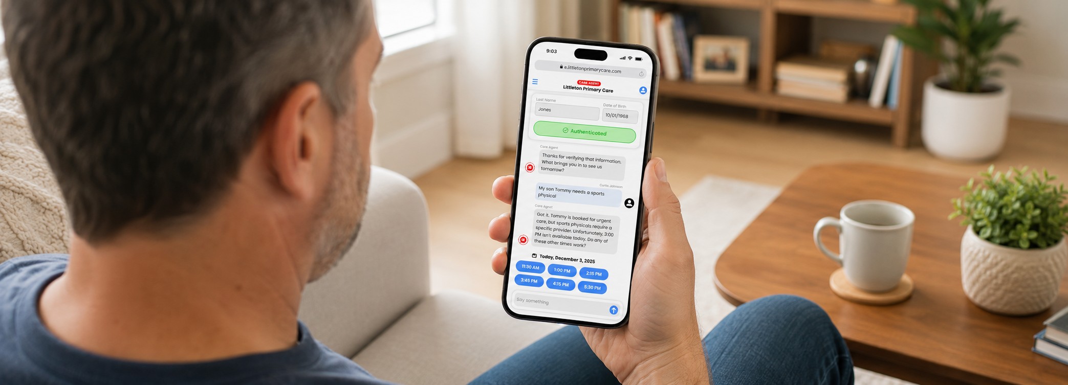 a man is sitting on a sofa in a well lit family room. he's looking at his phone, which has patient intake info displayed