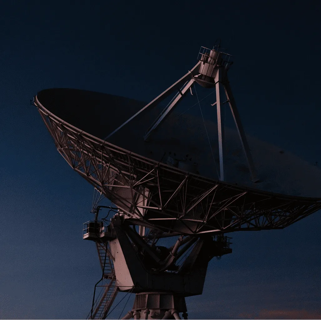 Large radio telescope dish silhouetted against a darkening evening sky.
