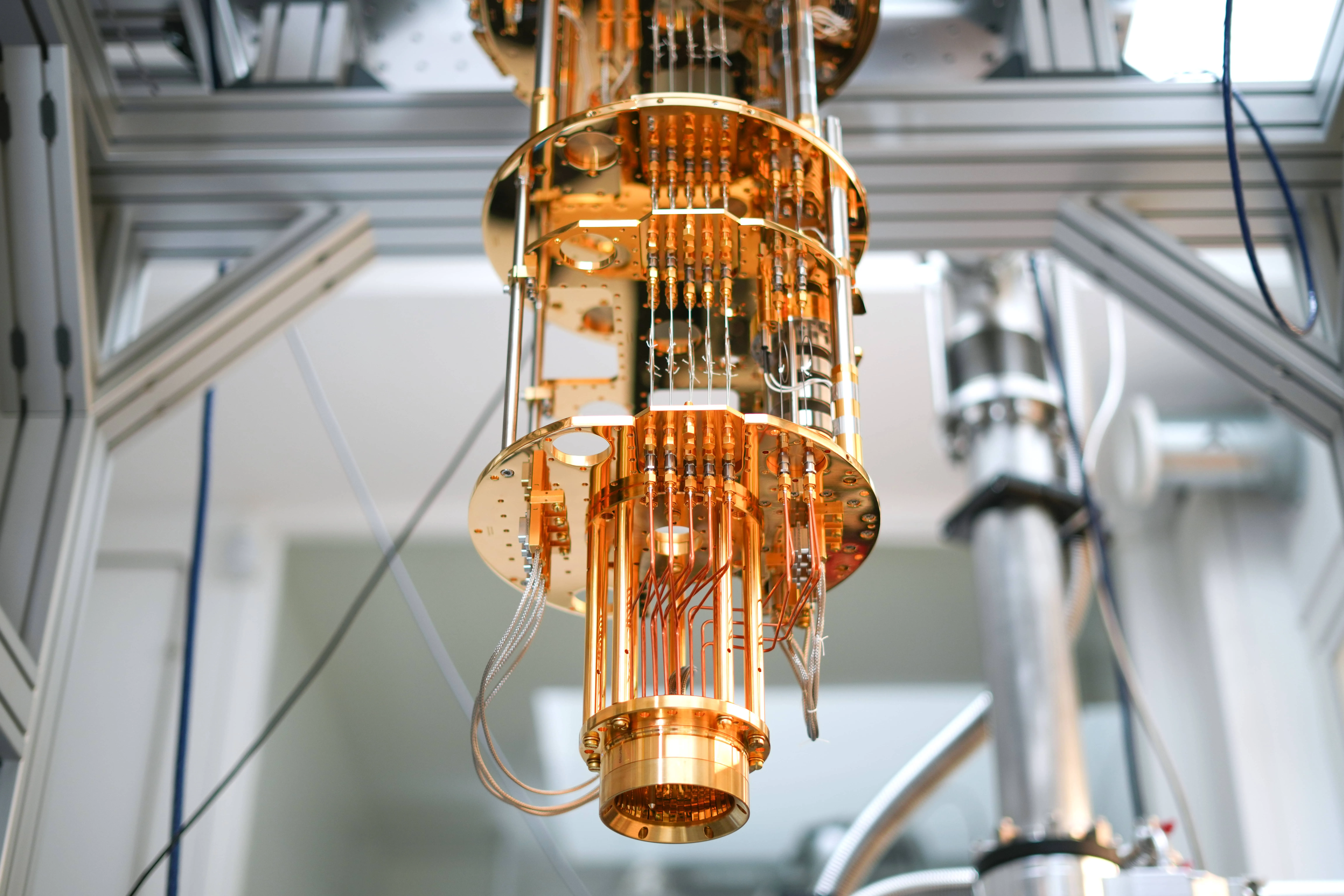 Person wearing a white checkered coat and blue hairnet opening transparent plastic curtains in a sterile, industrial environment.