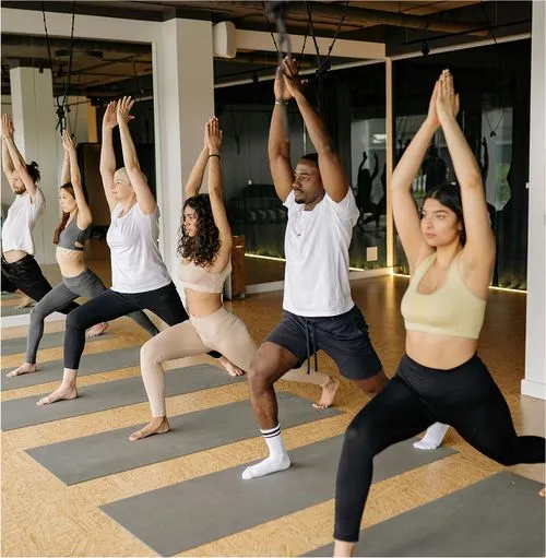 Group yoga practice in mirrored studio