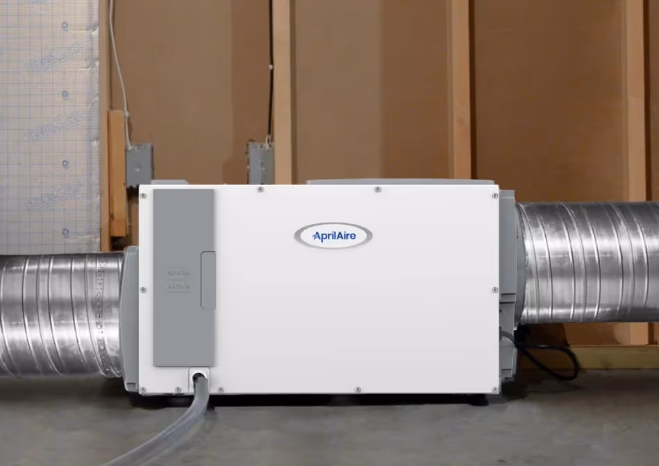 Aprilaire dehumidifier unit connected to ductwork.