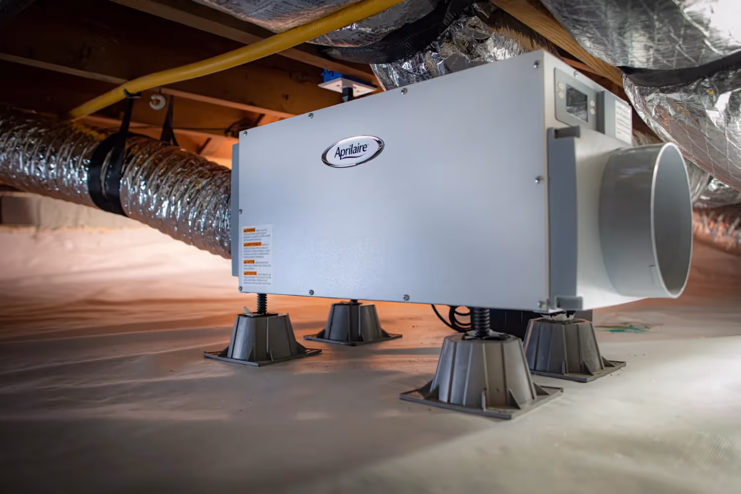 Aprilaire dehumidifier unit on adjustable risers.