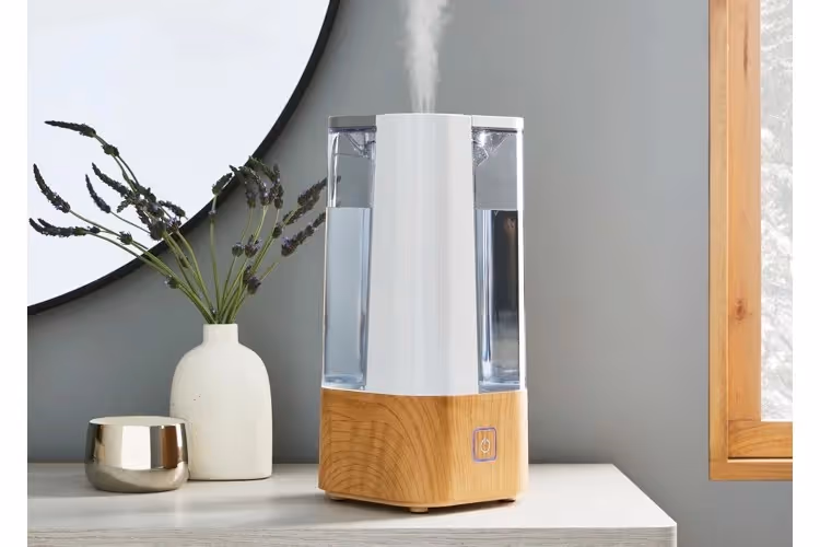 Wood base humidifier emitting white mist.