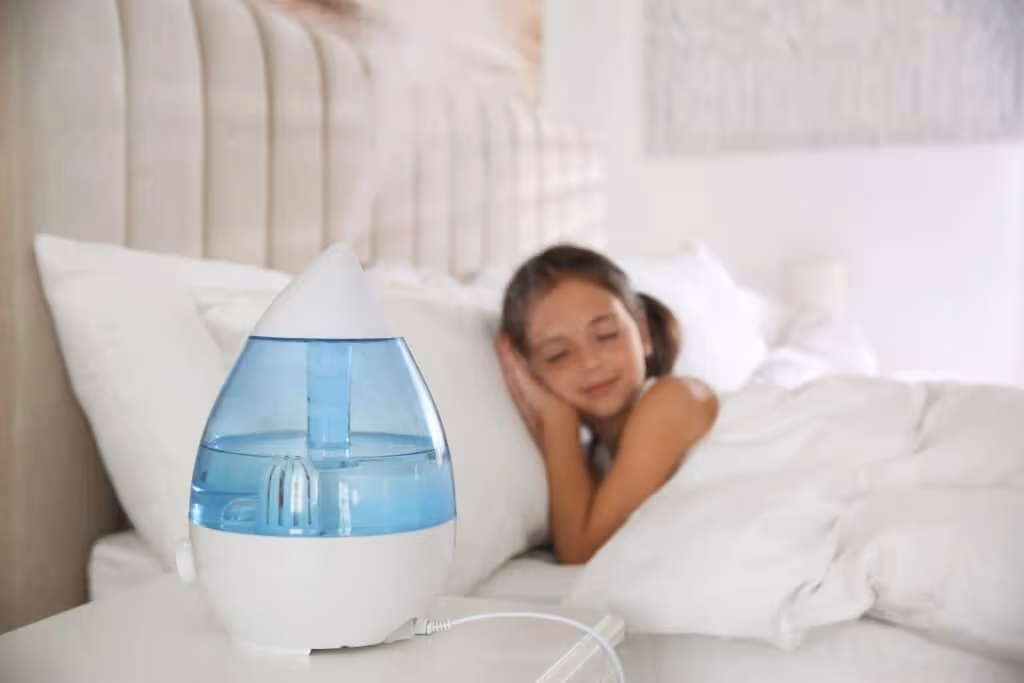 A blue teardrop humidifier by a child.