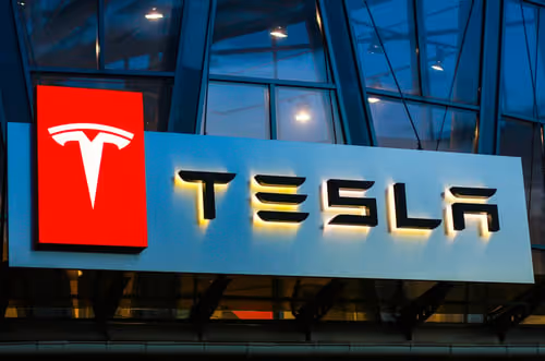 Illuminated Tesla sign at night