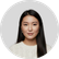 Portrait of a young Asian woman with long black hair wearing a white shirt against a plain white background.