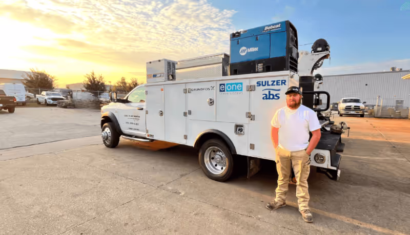 An Iowa Pump Works team member standing by a truck