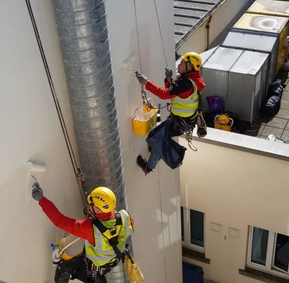 Rope access technicians are painting the building in Edinburgh