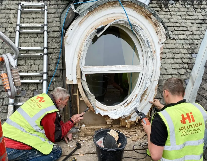 Two roofers are fixing the roof light