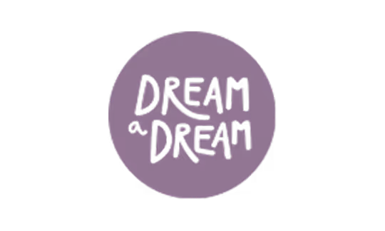 Purple circle with the phrase 'DREAM a DREAM' written in black hand-drawn letters.