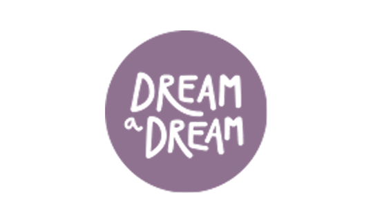 Purple circle with the phrase 'DREAM a DREAM' written in black hand-drawn letters.