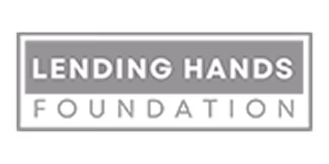 Text logo reading Lending Hands Foundation with Lending Hands in white uppercase letters on a gray background and Foundation below in gray uppercase letters on a transparent background.