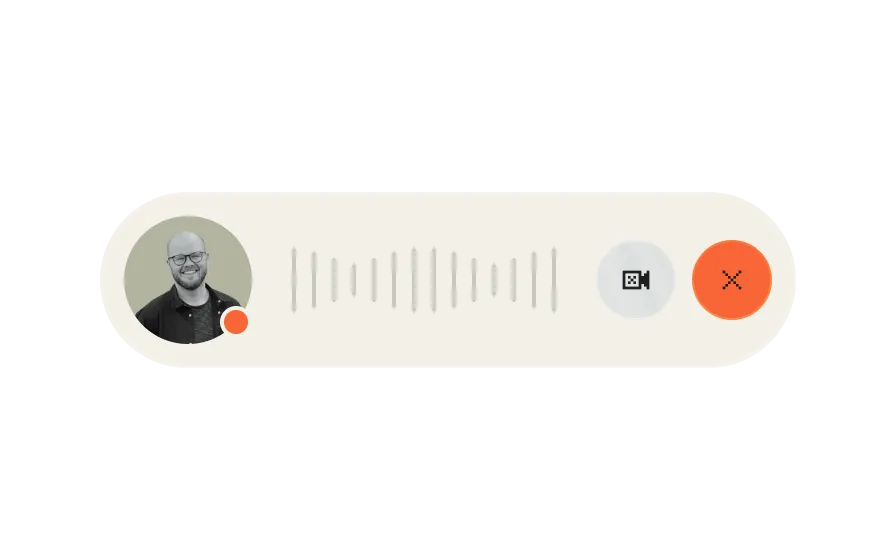Audio call interface showing a smiling bald man, audio waveform, video camera button, and red hang-up button.