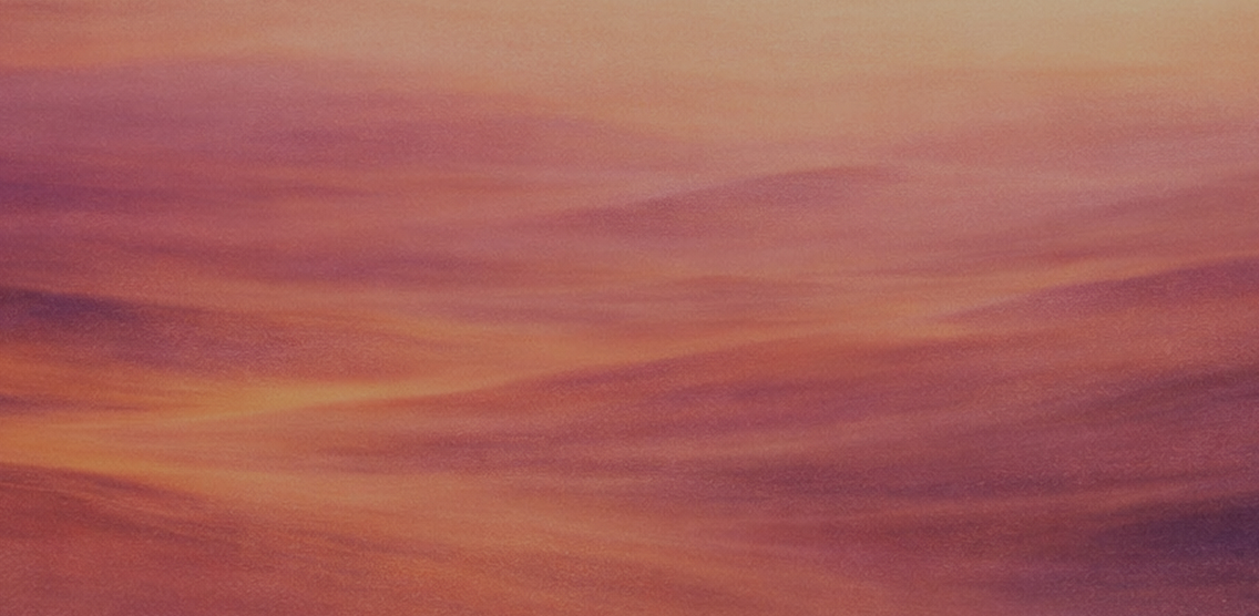 Abstract gradient background with soft blending colors of orange, purple, and pink.
