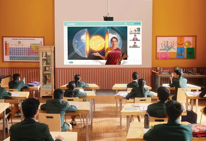 Classroom with students in uniforms watching a virtual science lesson about the Earth's core projected on a screen.