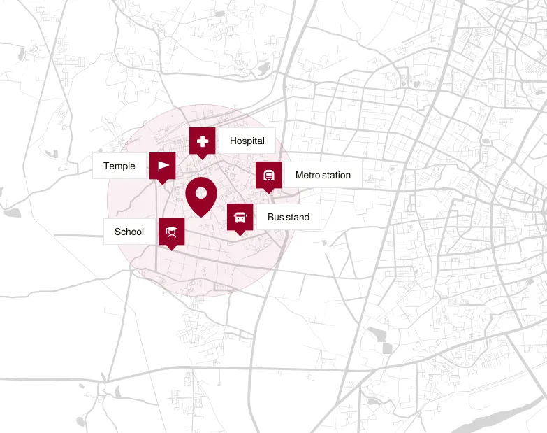 Map with location marker surrounded by icons for hospital, metro station, bus stand, school, and temple within a shaded area.