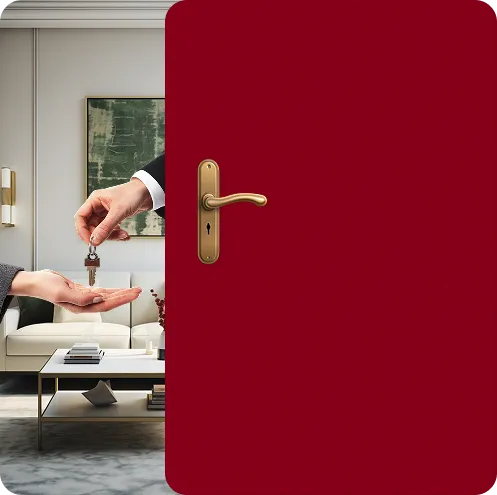 Hand passing a small house key to another hand through a partially open red door with a golden handle, showing a modern living room in the background.