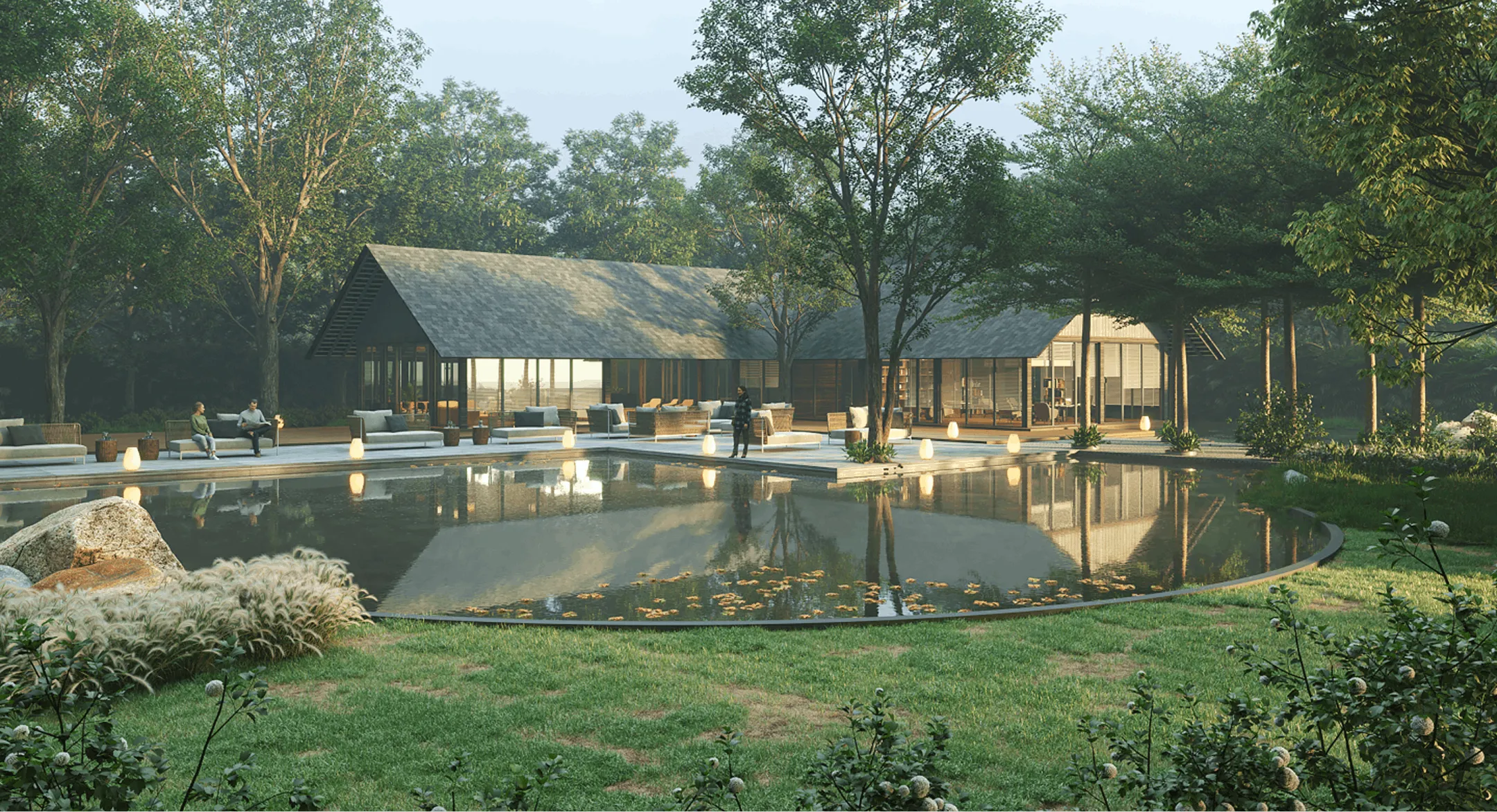 Modern house with large glass windows reflected in a calm pond surrounded by lush greenery and outdoor seating.