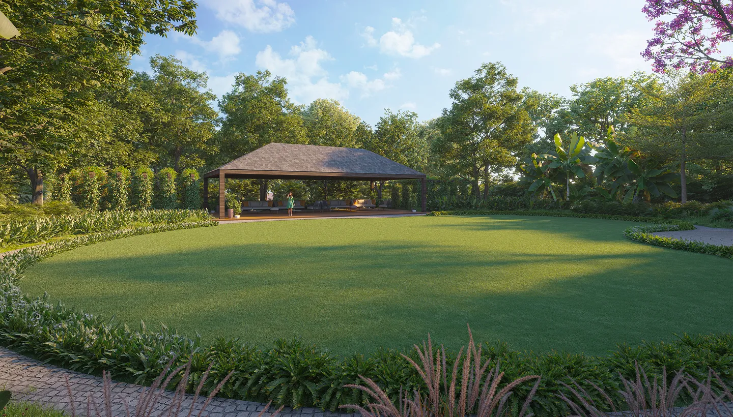 Modern house with large glass windows reflected in a calm pond surrounded by lush greenery and outdoor seating.