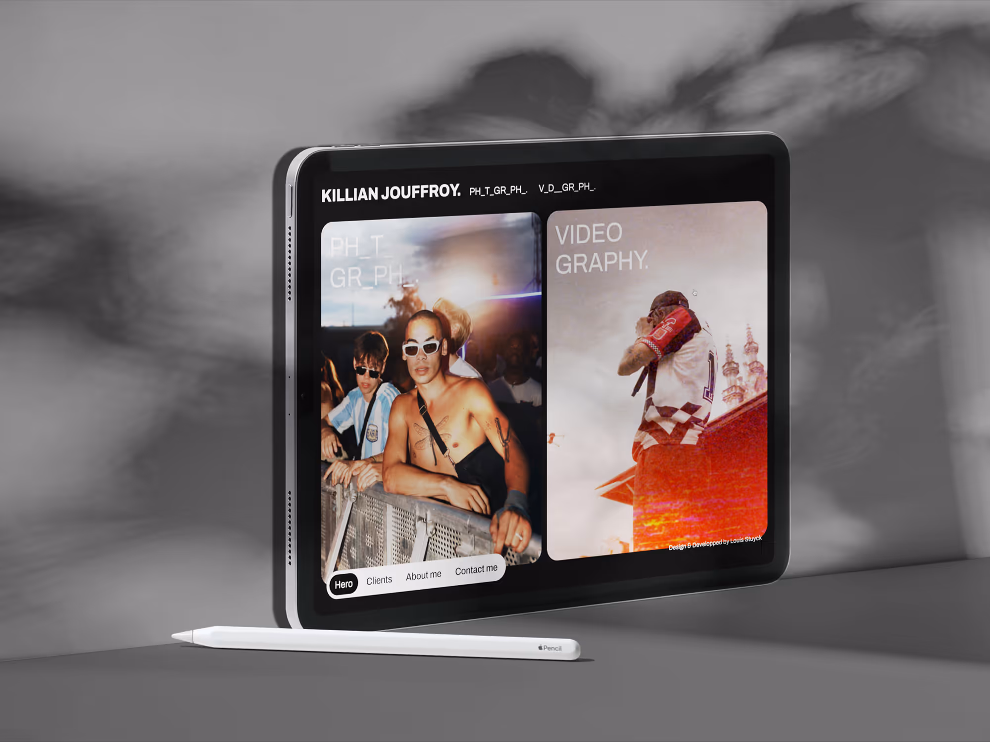 Tablet device displaying photography and videography Killian Jouffroy's portfolio with two images, accompanied by a white stylus pen on a gray surface.