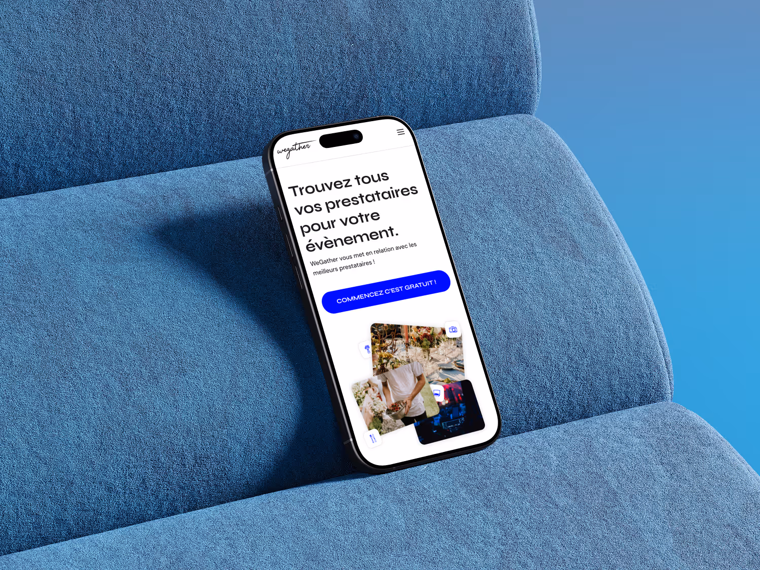 Smartphone resting on a blue textured fabric surface displaying Wegather website event service app with a call-to-action button.