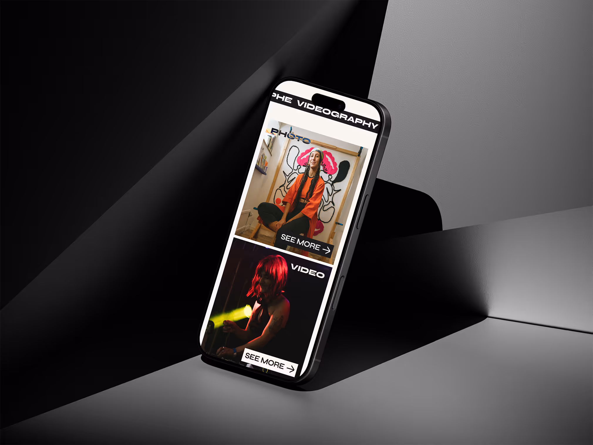 Smartphone displaying Tamara Leroy website with two sections: a photo of a woman in an orange outfit and a video still of a person with red hair holding a microphone, each with 'SEE MORE' buttons.