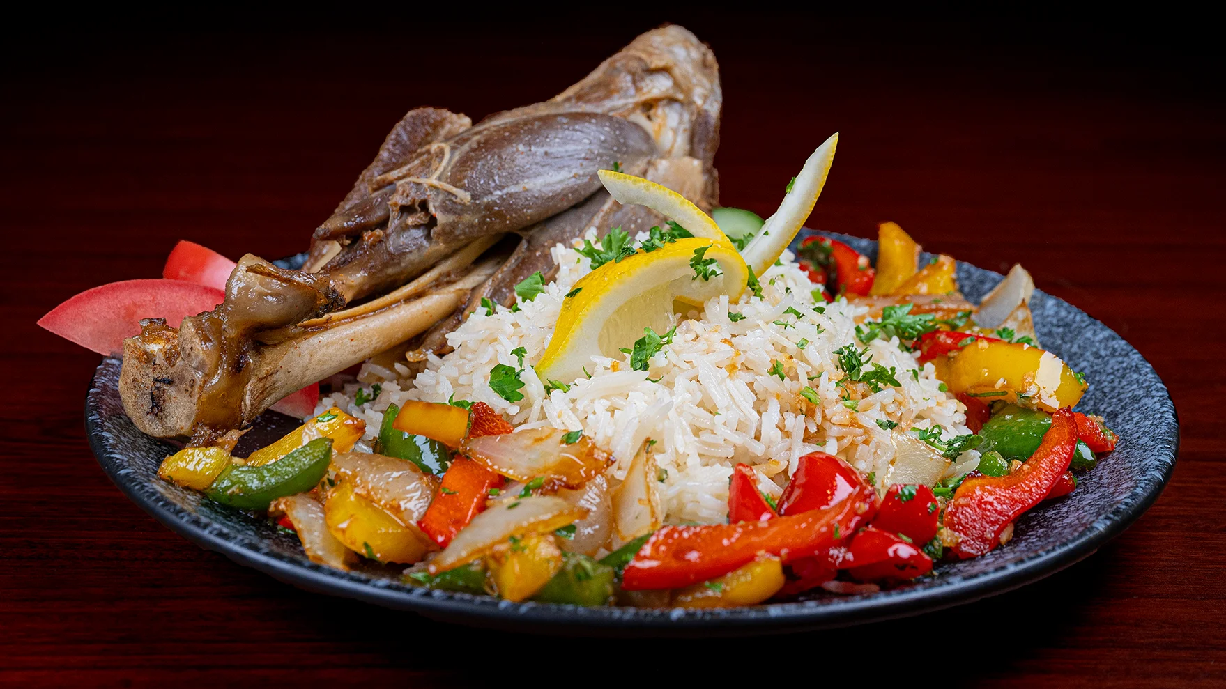 A plate of food with rice, meat, and vegetables.