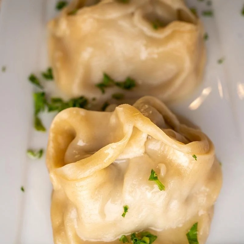 Two pieces of food on a white plate.