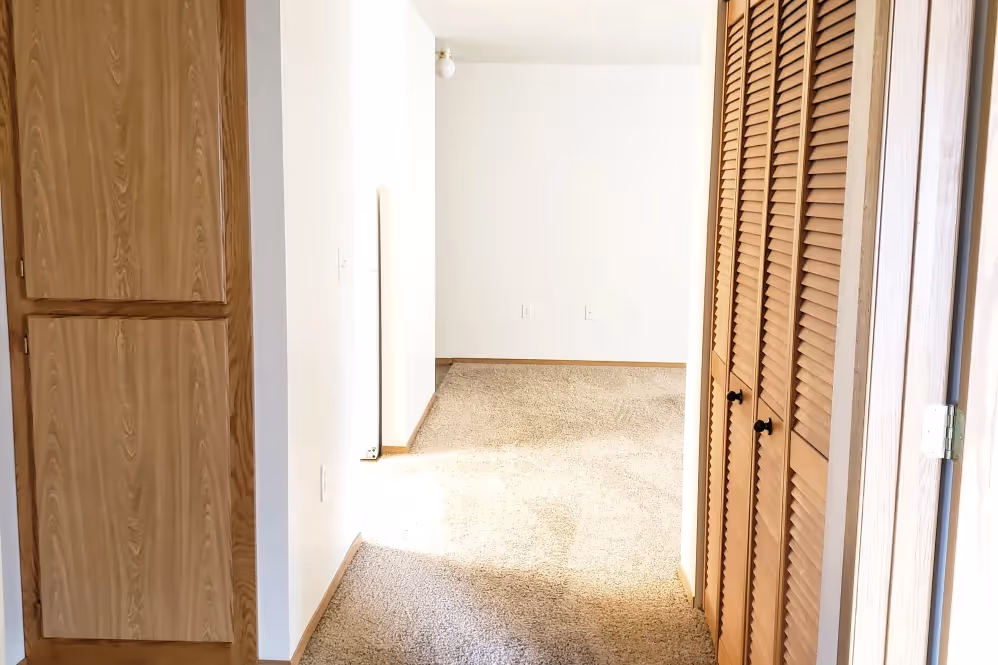 Hallway with brown cabinets