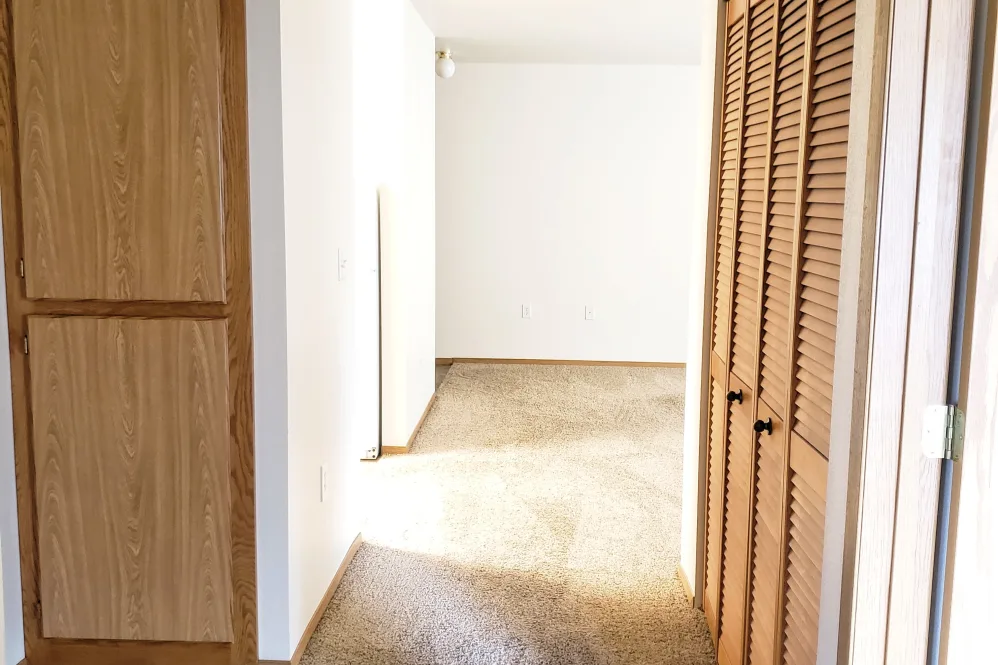 Hallway with brown cabinets