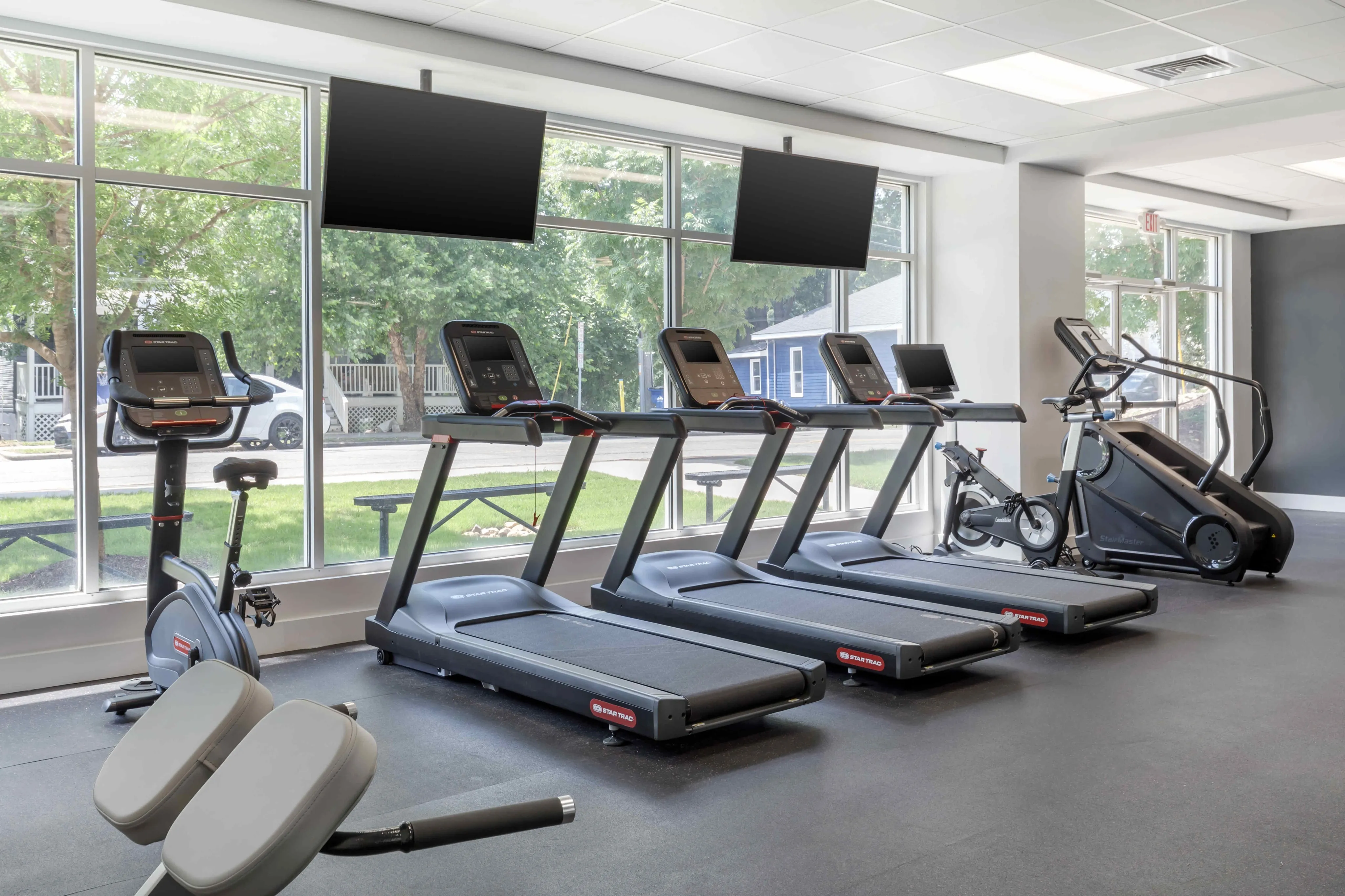 gym with treadmills and large window