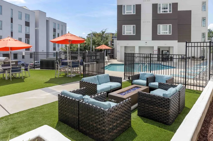 outdoor lounge area with tables, chairs and umbrellas