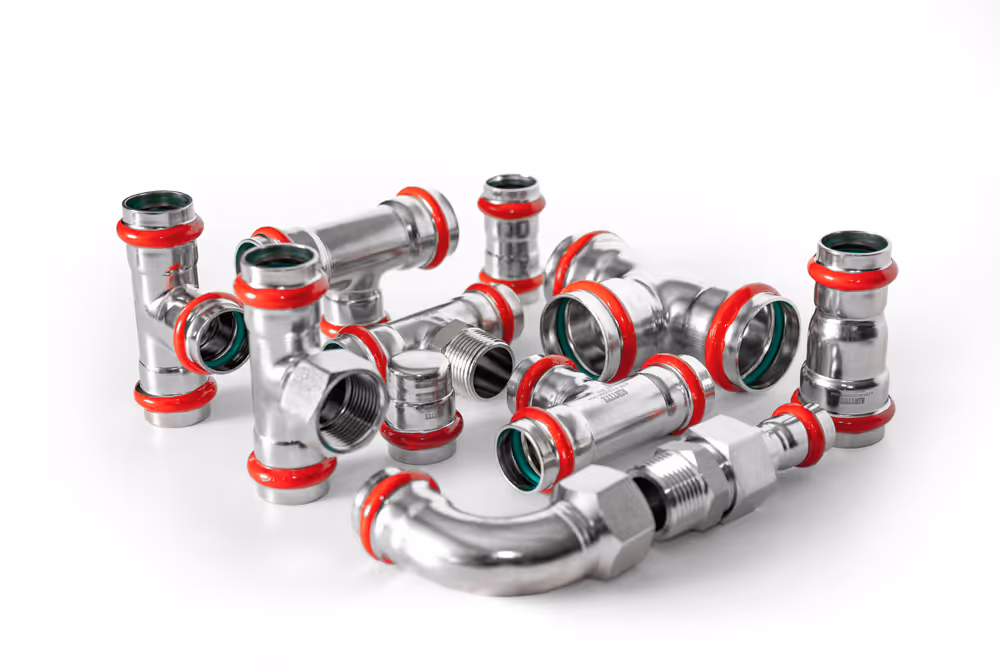 Various stainless steel pipe fittings including elbows and tees arranged on a white background.