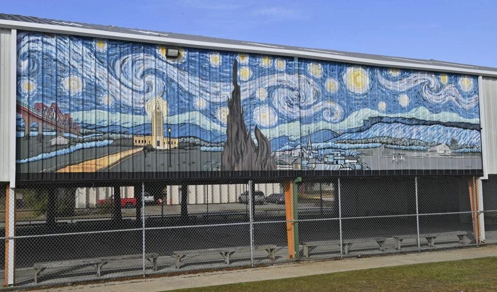 Starry Night–style mural depicts Baton Rouge landmarks across stadium bleachers.