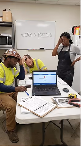 Three construction workers look stressed at a table with documents and laptop showing a work portal.