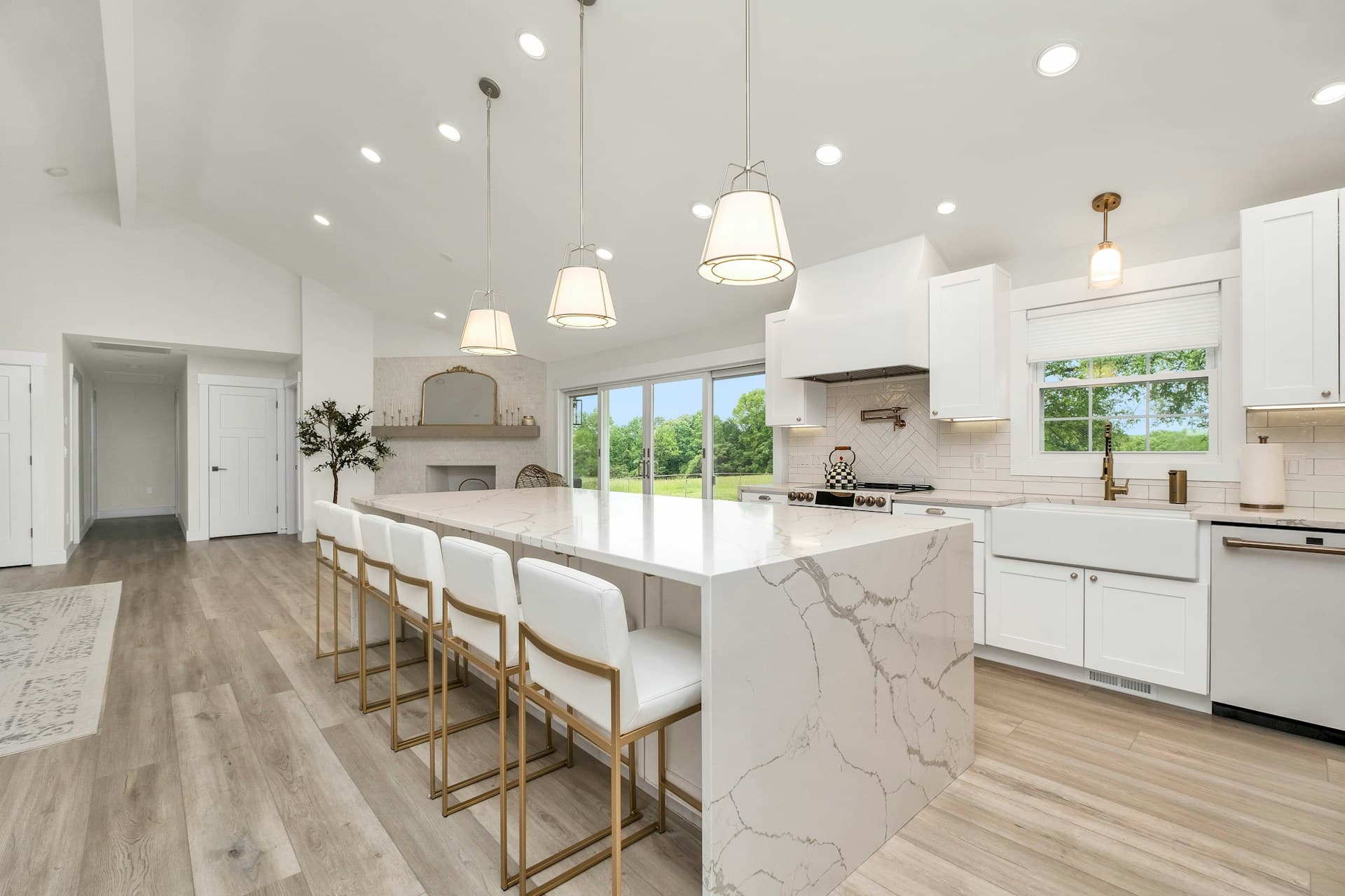 Bright kitchen under renovation with cabinets, countertop covered in protective plastic, and a folding ladder.