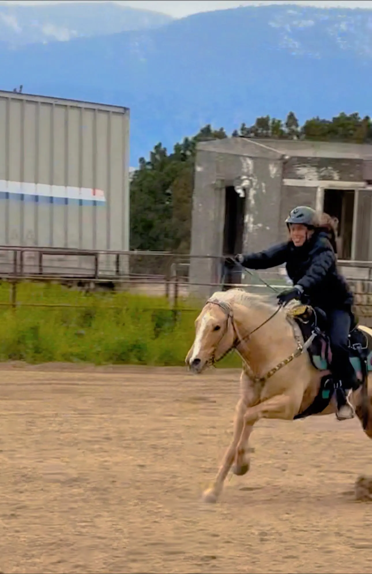 Rider in western horseback riding near me on tan horse