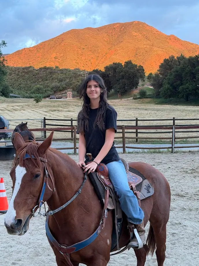 Rider on horseback with orange mountains in the background