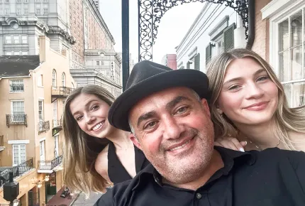 Two beautiful young blonde women and a handsome man wearing a hat at a top creative marketing agency’s company retreat in New Orleans.