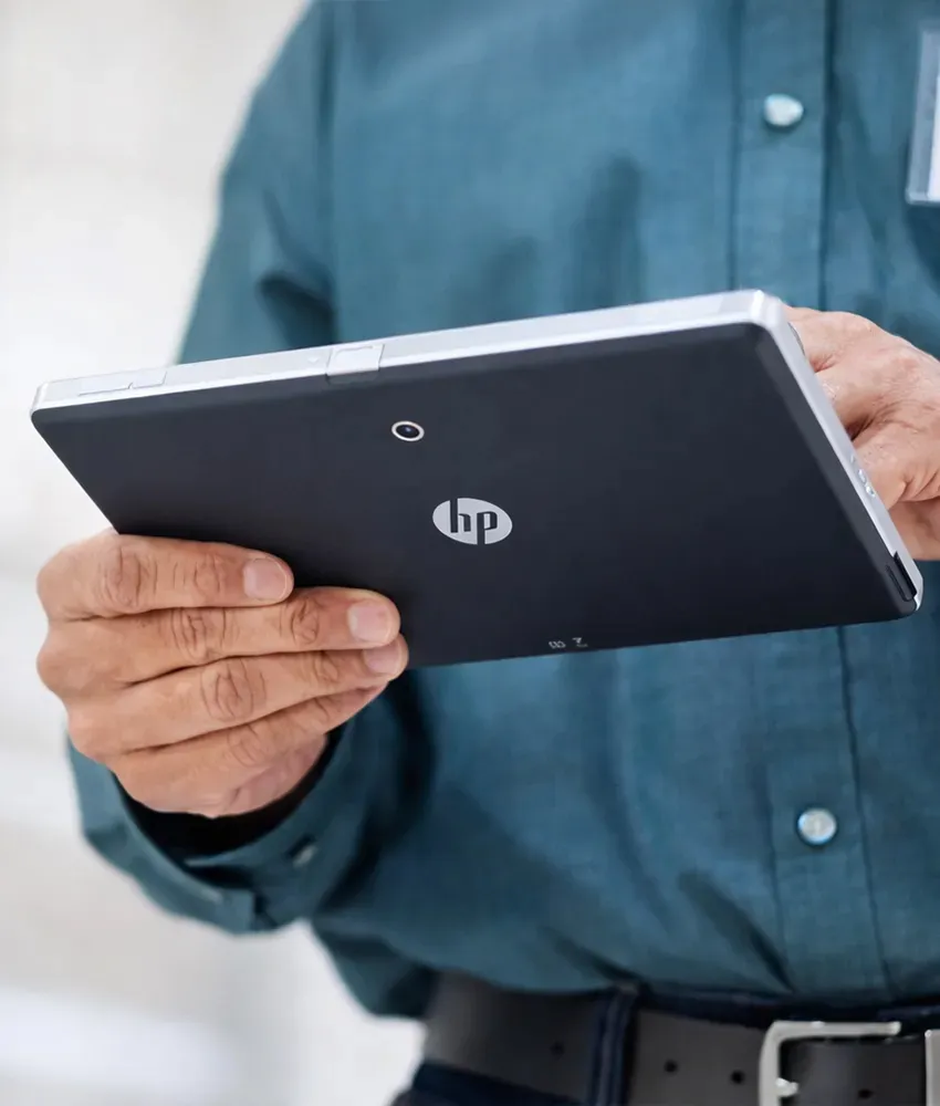 A man holding an HP tablet. 