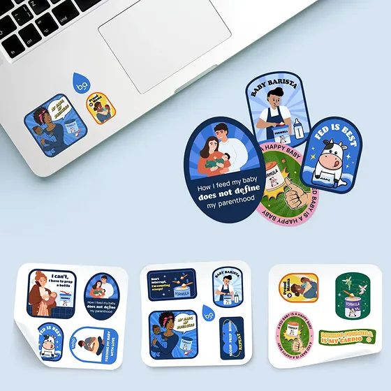 Veba Baby branded stickers for bottle feeding mothers next to an open laptop, designed by one of the best creative marketing agencies for baby brands.