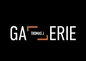 White, orange, and black logo with GALLERIE with both Ls tilted like a frame with Thomas J. inside, designed by a top marketing agency. 