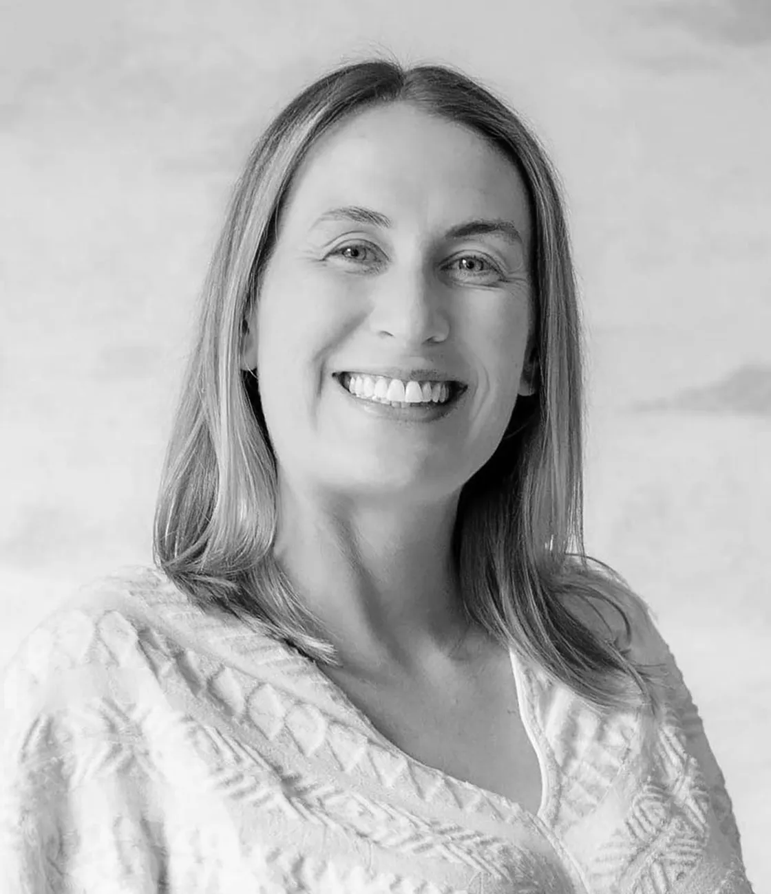 A beautiful Caucasian female paid media marketing professional with long blonde hair smiling.