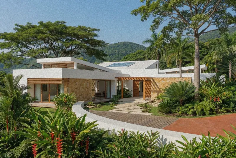 Modern multi-level house with large wooden overhangs, stone walls, lush greenery, and distant mountain and ocean views under a cloudy sky by Proof El Salvador.